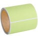 A roll of green labels with a white background.