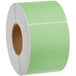 A roll of green labels on a white background.