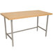 An Advance Tabco wood top work table with a stainless steel base.