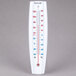 A white Taylor wall thermometer with red and blue numbers.