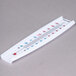 A white Taylor wall thermometer with red and blue text.