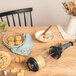 A table with a bowl of food, a white object, and a de Buyer Le Tube Pastry Press on it.