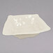 A white square bowl with a rounded edge.