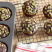A chocolate muffin with Bob's Red Mill Raw Organic Pumpkin Seeds on top.