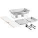 A silver aluminum foil tray with Choice utensils and a metal tray of food.