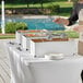 A man using a Choice chafer dish kit to prepare food on a buffet table.