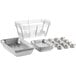 A stack of aluminum foil trays and containers with wire racks.