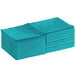 A stack of teal 2-ply beverage napkins.