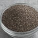 A glass bowl filled with Bob's Red Mill Organic Whole Chia Seeds.