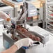 A person wearing a white glove using a ChocoVision skimmer to make chocolate.