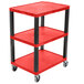 A red Luxor utility cart with three shelves and wheels.