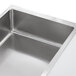 A ServIt stainless steel ice-cooled food table with a sneeze guard over pans of food.