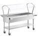 A stainless steel ServIt ice-cooled food table with sneeze guard and casters.