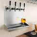 A Regency wall mounted beer drip tray with four beer glasses on it.