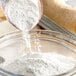 A bowl of Malt Products Tapioca Starch being poured into a bowl.