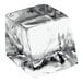 A clear medium cube of ice with a few ice cubes.