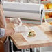 A person wearing gloves uses Choice wet wax paper to prepare a sandwich.