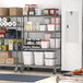 A Metro gray wire shelving unit in a kitchen with food containers on the shelves.