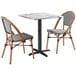 A Lancaster Table & Seating Versilla table with 2 French Bistro chairs.