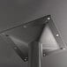 A close up of a black metal pole with screws.