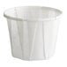 A small white paper souffle or portion cup.