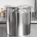 A Galaxy stainless steel bain marie pot on a countertop with plastic wrap on top.