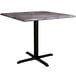 A Lancaster Table & Seating square table with a black base and marble top.