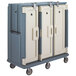 A slate blue Cambro meal delivery cart with three doors and wheels.