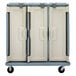 A slate blue Cambro meal delivery cart with three compartments.