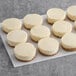 A tray of Tennessee Cheesecake Original Petite Cheesecakes on a white surface.