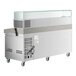 An Avantco stainless steel refrigerator with a stone top and glass sneeze guard.