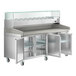 An Avantco stainless steel refrigerated pizza prep table with a glass top.
