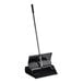 A black dustpan with a long handle.