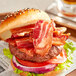 A bacon sandwich on a paper plate.