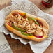 A sandwich made with Original Philly Cheesesteak Co. Marinated Chicken Steak slices, peppers, and onions on a plate.
