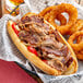 A sandwich with Original Philly Cheesesteak Co. marinated beef steak and onions.