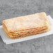 A stack of Original Philly Cheesesteak Co. marinated chicken sandwich steaks on a white surface.