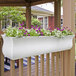 A white rectangular Mayne Valencia window box with purple flowers.