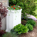 A white rectangular container with flowers in it.