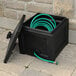 A black Mayne Fairfield garden hose bin with a hose in it.