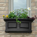 A Mayne Nantucket window box with flowers in it.