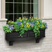 A Mayne Nantucket window box with flowers in it.