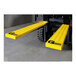 A pair of yellow GenieGrips rectangular safety mats on a forklift.