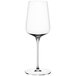 A close-up of a clear Spiegelau white wine glass with a long stem.