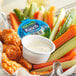 A case of 160 Hidden Valley Ranch dressing cups on a table with a bowl of chicken wings and vegetables.