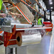 A person in a green vest using a Lavex Pro machine to pack plastic bags with Lavex Pro perforated shrink film.