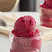 A glass cup with a scoop of pink Sambazon Organic Dragon Fruit Pitaya Sorbet.