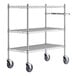 A Regency chrome metal utility cart with three shelves and wheels.