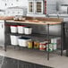 A kitchen with a counter and shelves with a Regency 3-shelf kit on the counter.