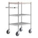 A Regency chrome utility cart with three metal shelves and wheels.